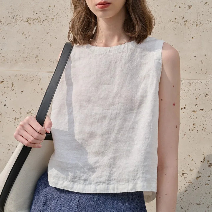 Women's asymmetric crop top, sleeveless with crew neck. Modern relaxed fit for chic summer style.