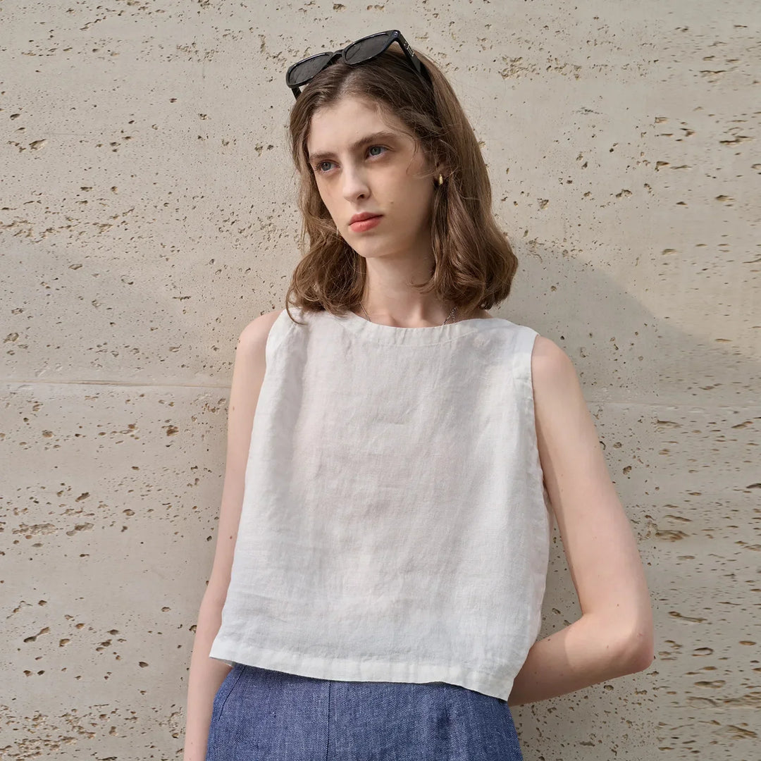 Trendy pink asymmetric crop top, sleeveless for women. Chic, comfortable, & perfect for summer minimalist style.