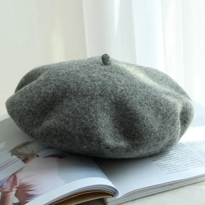 Cozy green women's winter beret hat, warm headwear, a stylish classic accessory.