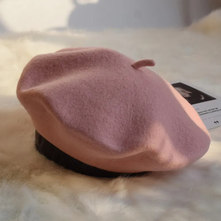 Soft pink women's beret, fashionable and warm winter hat, a chic headwear accessory.