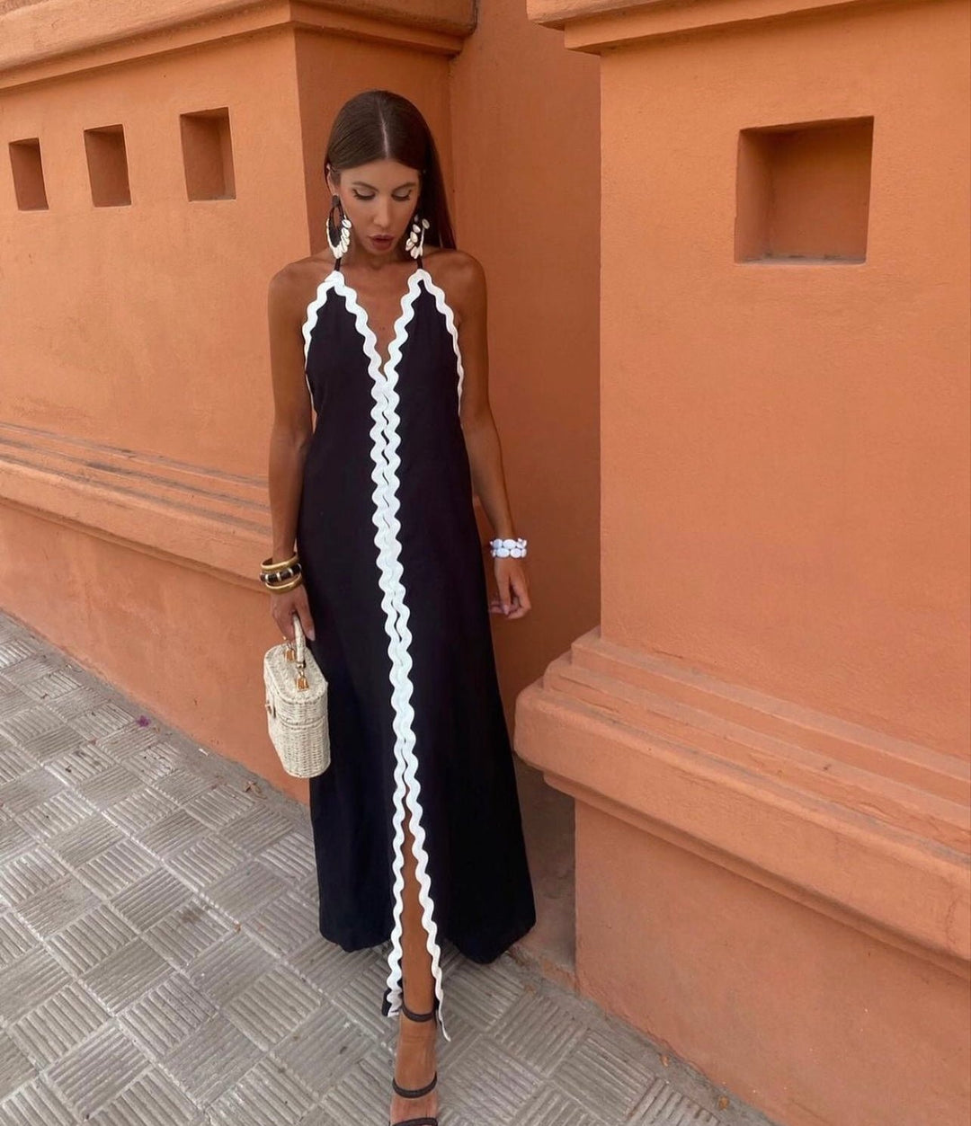 Chic sleeveless maxi wedding guest dress with elegant contrast trim & V-neck. Perfect for summer events.