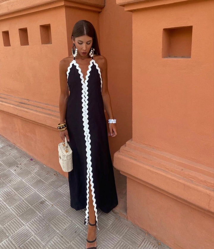 Chic sleeveless maxi wedding guest dress with elegant contrast trim & V-neck. Perfect for summer events.