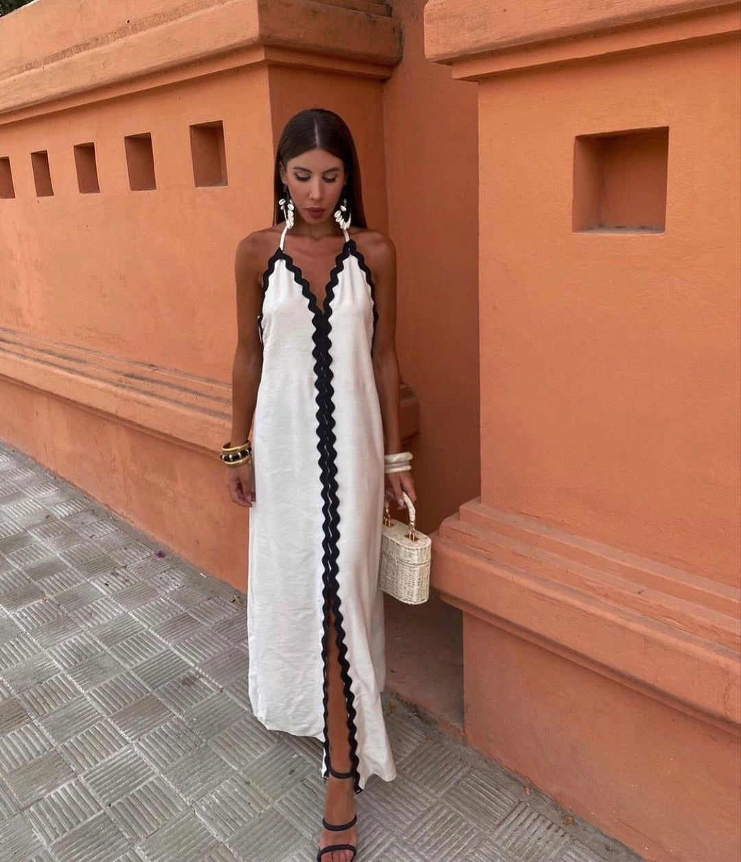 Elegant women's formal maxi dress. Black & white contrast trim, V-neck, flowing design. Ideal for special occasions.