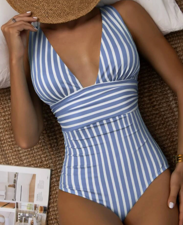 Elegant striped one-piece for women, designed for a flattering fit and summer style.