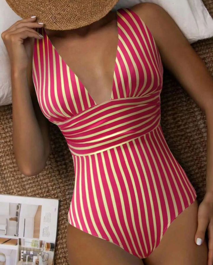 Fashionable one-piece swimwear for women with elegant stripes, ideal vacation wear.
