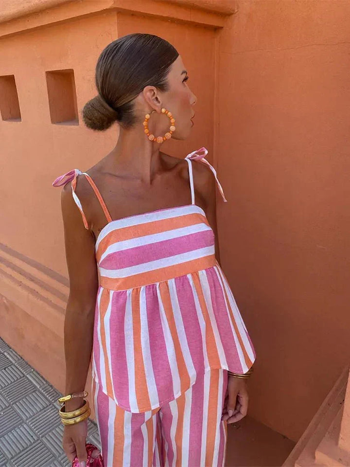 Stylish women's chic striped wide leg pant set with a flattering peplum top, perfect for special occasions.