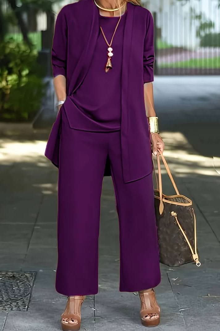 Flat lay of a women's 3-piece summer loungewear set, including a top, flowy pants, and a lightweight coverup.