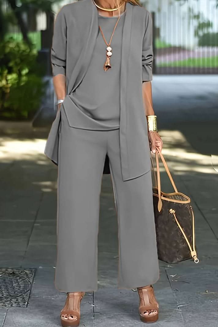 Back view of a women's 3-piece summer resort wear set, highlighting the elegant flowy pants and lightweight coverup.