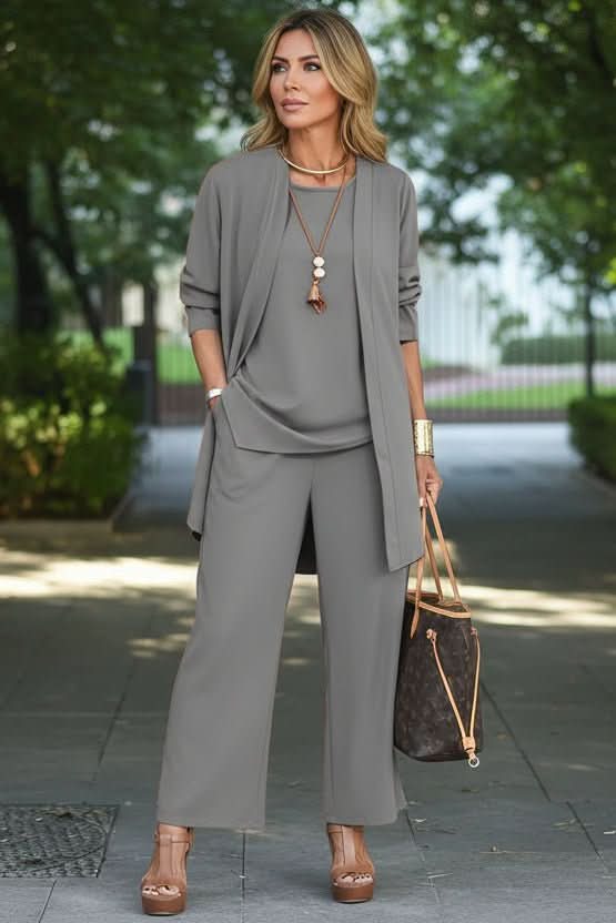 Elegant women's 3-piece summer resort wear set. Features flowy pants & a lightweight coverup for beach days.