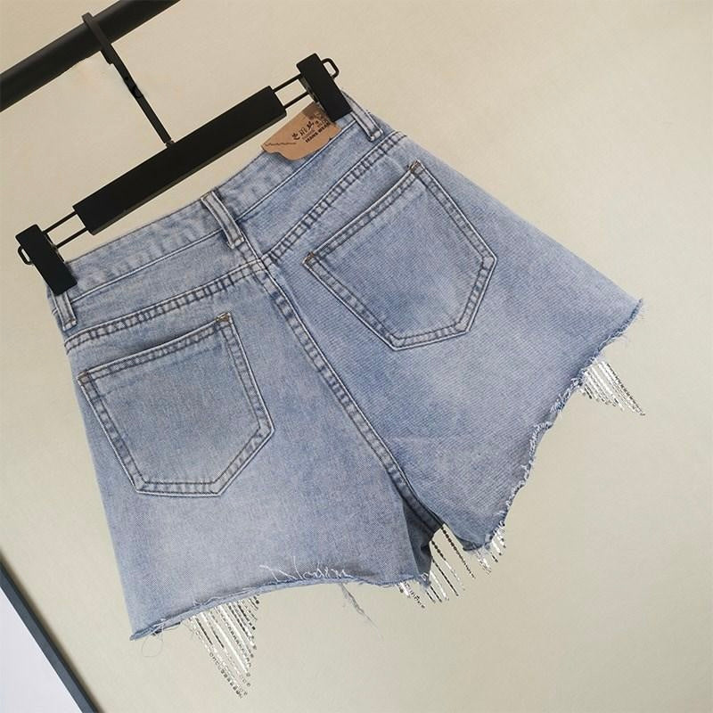 Stylish blue tassel shorts for women, a trendy fashion bottom for comfortable summer casual wear.