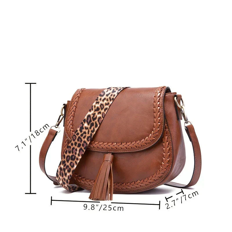 Must-have women's chic saddle bag in versatile brown, accessorized with a trendy tassel, for any occasion.