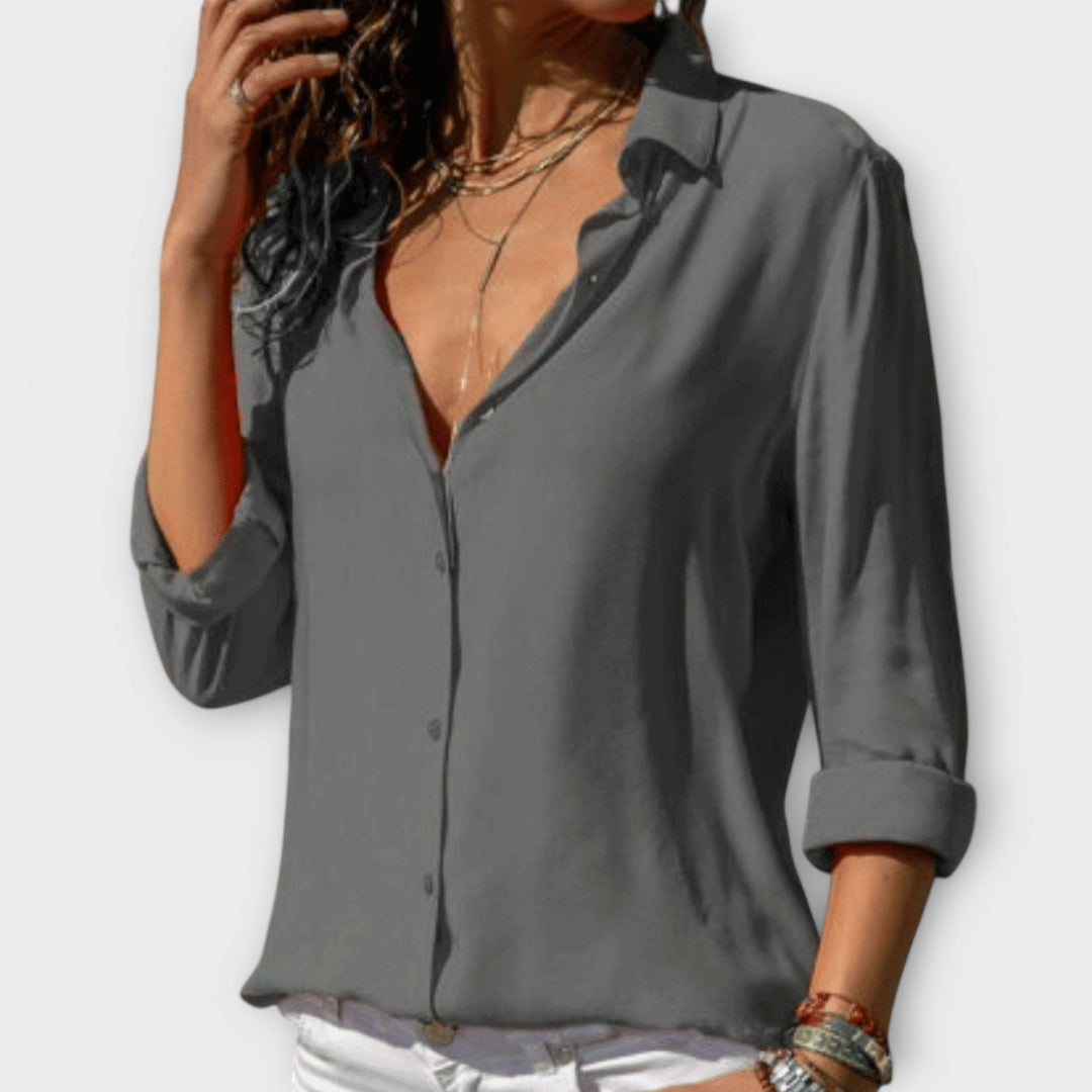 Fashionable women's chic blouse, a stylish long sleeve top suitable for professional office attire or classy evening wear.