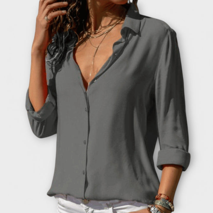 Fashionable women's chic blouse, a stylish long sleeve top suitable for professional office attire or classy evening wear.