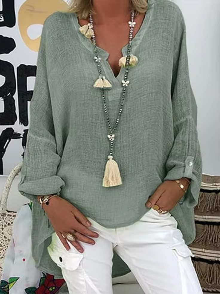 Elegant women's oversized blouse, a versatile long sleeve top for casual chic or summer beachwear. Relaxed modern fashion.