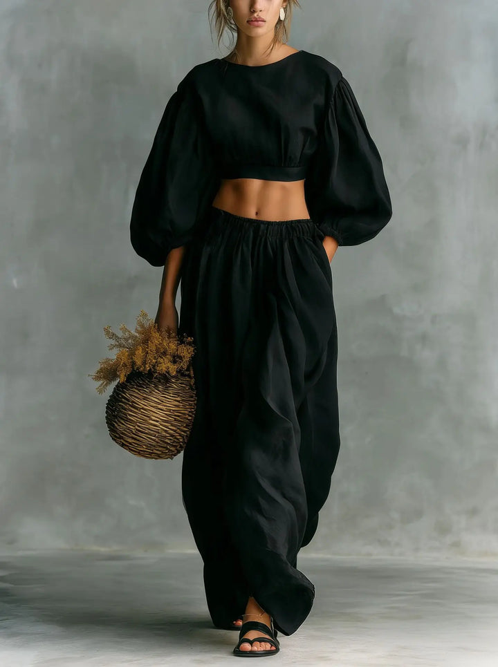 Stylish women's relaxed fit two-piece trouser set. Features chic balloon sleeves & wide-leg pants for comfort.