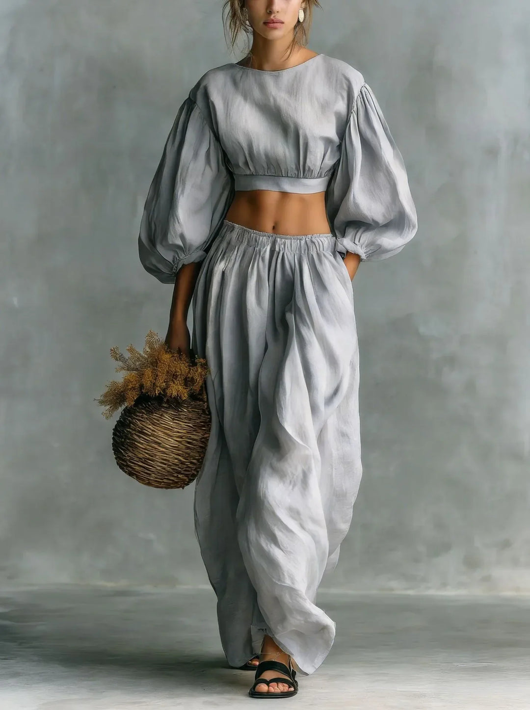Women's two-piece outfit showcasing elegant balloon sleeves & comfortable wide-leg trousers. Ideal casual wear.