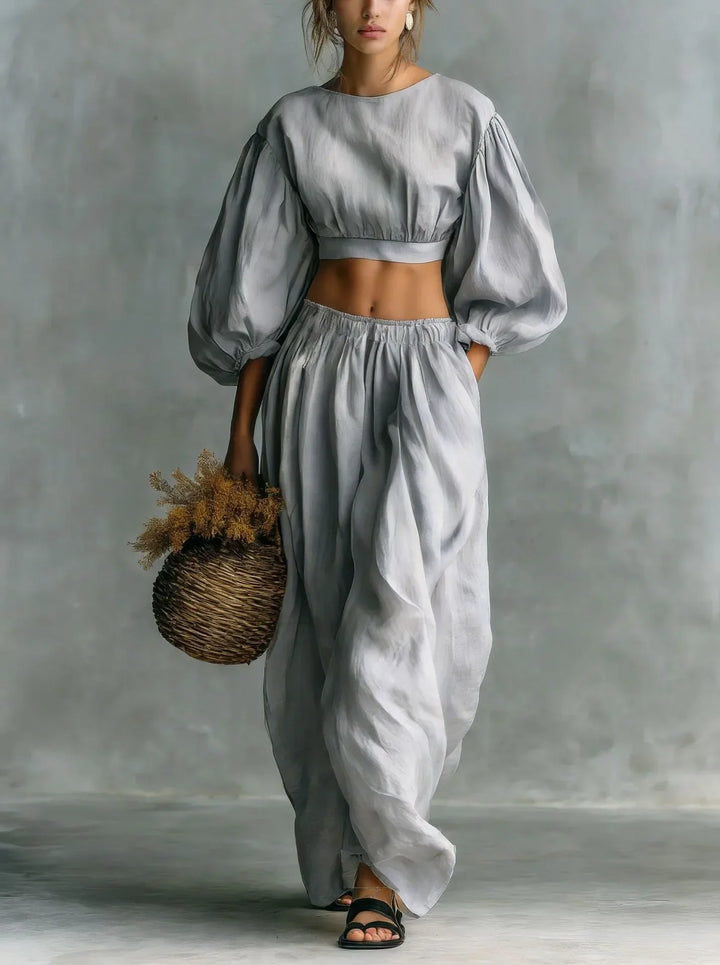 Women's two-piece outfit showcasing elegant balloon sleeves & comfortable wide-leg trousers. Ideal casual wear.