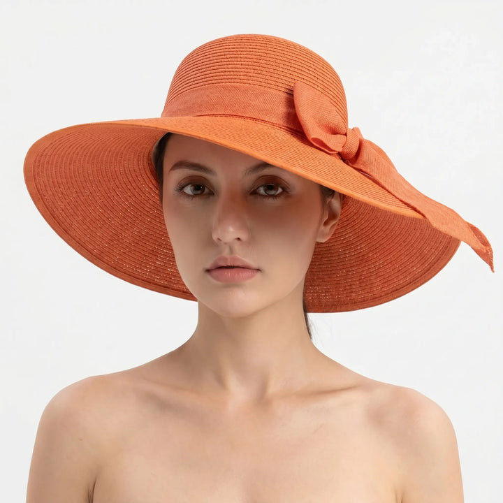 Women's foldable wide brim beach hat, ideal for sun protection during summer travel. A stylish accessory.