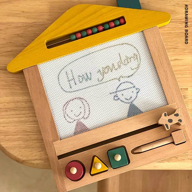 Child playing with wooden magnetic drawing board and included eraser, learning toy for toddlers.