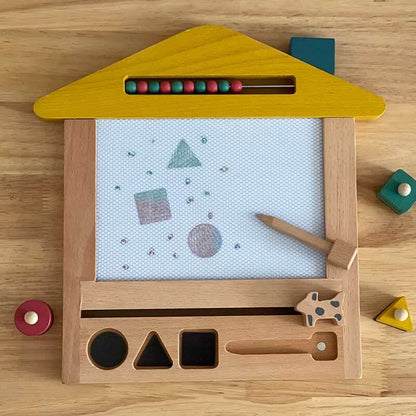 Kids drawing board, wooden magnetic type, with a child's hand using the magnetic pen.