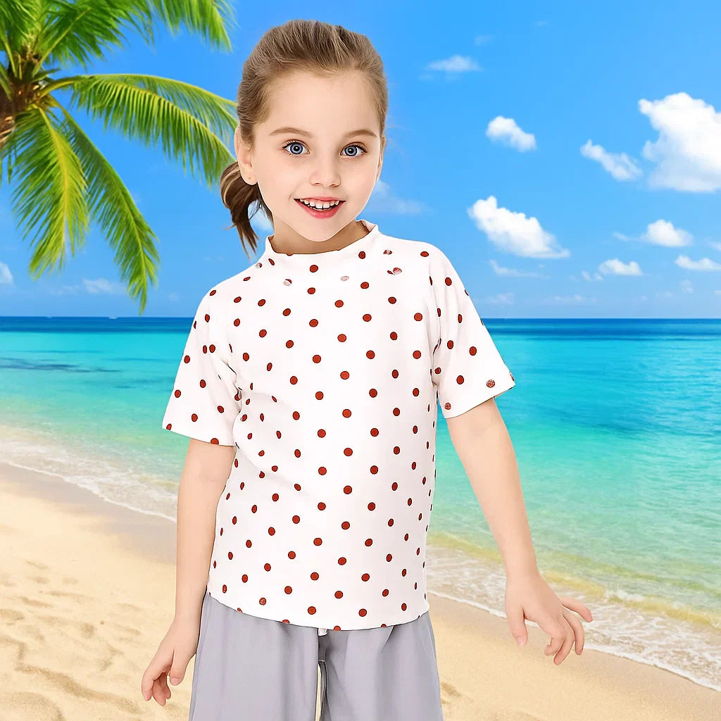 Young boy wearing a blue anti-UV swim shirt, enjoying water play with sun protection.