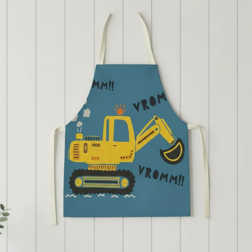Happy child wearing a dinosaur-themed apron, enjoying cooking or art time activity