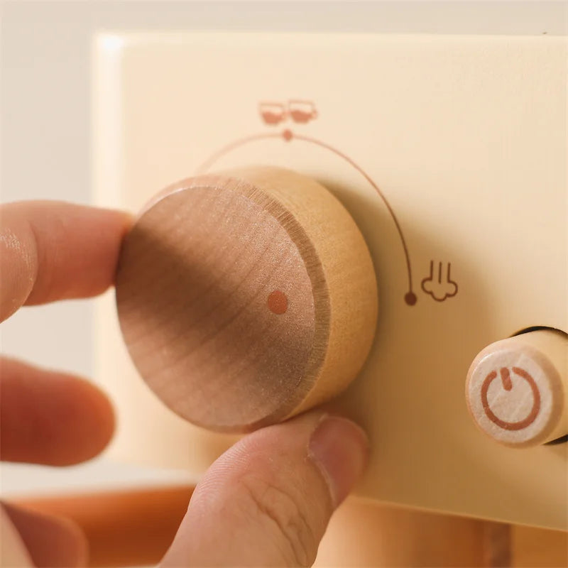 Close-up of child's hand operating a wooden espresso machine toy, educational kitchen roleplay.