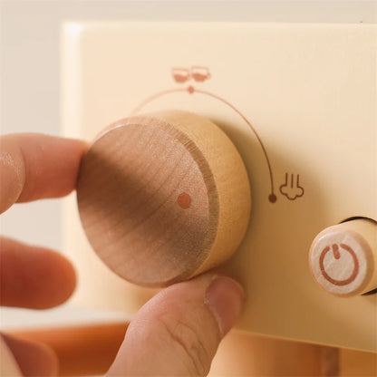 Close-up of child's hand operating a wooden espresso machine toy, educational kitchen roleplay.