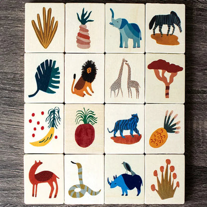 Close-up of a child matching wooden animal tiles from a jungle memory game, fostering cognitive development.
