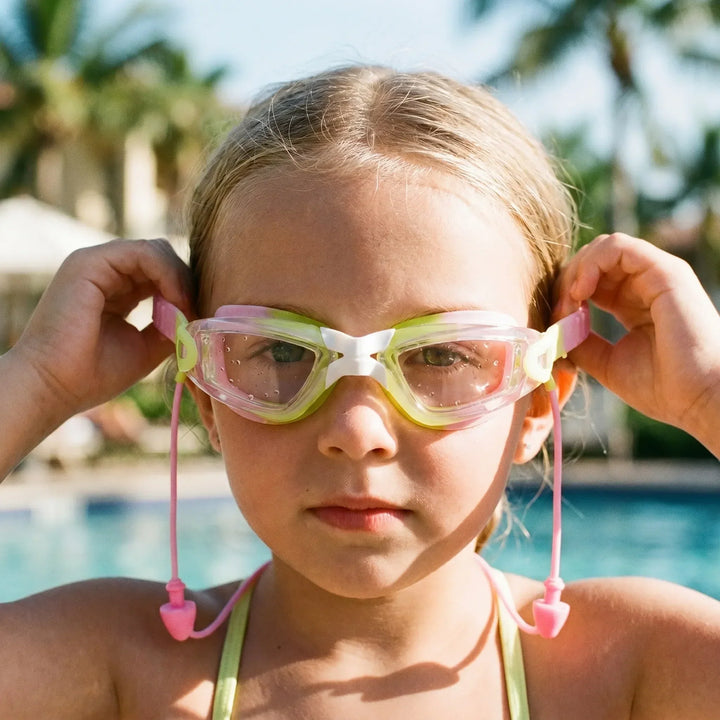 Children's anti-fog swimming goggles with integrated earplugs for clear vision & ear protection.