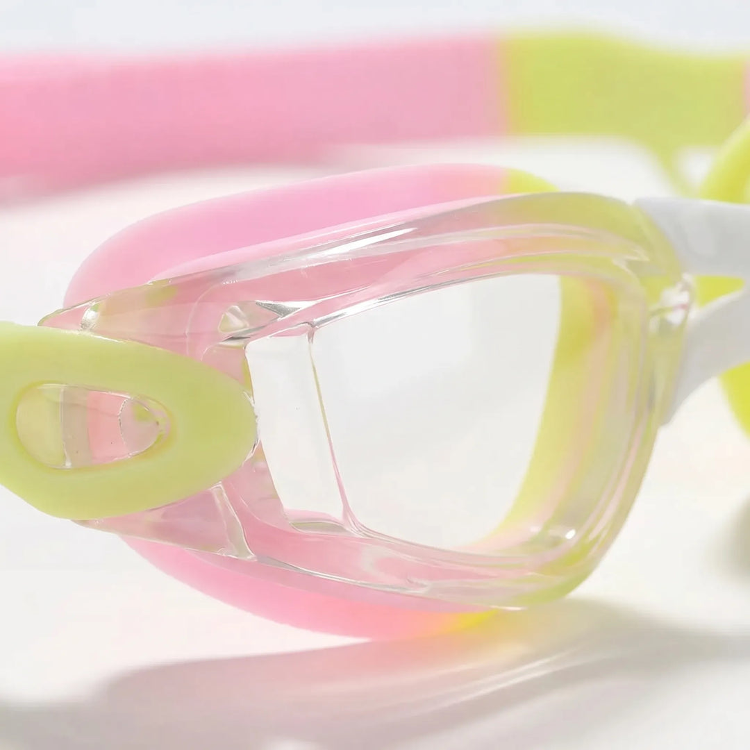 Youth swimming goggles featuring clear anti-fog lenses & soft integrated earplugs for comfort.