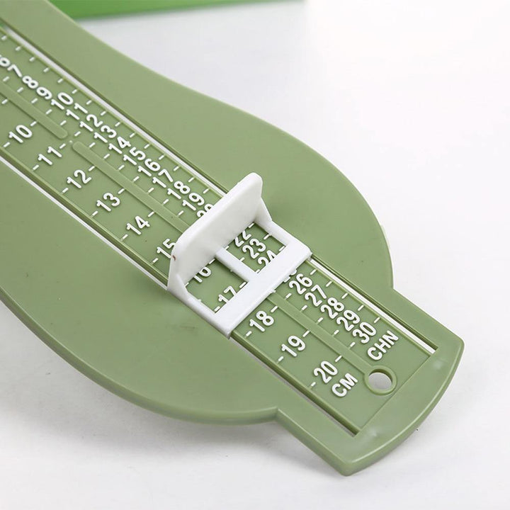 Grey baby foot gauge, a reliable home tool for accurate shoe fitting and development checks.