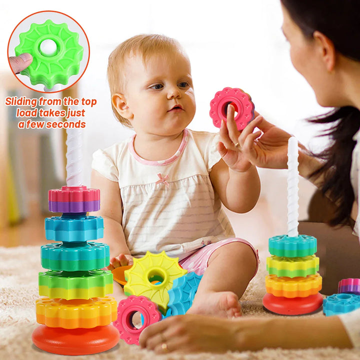 Toddler rotating stacking toy, bright rainbow colors. Enhances fine motor skills & problem-solving.