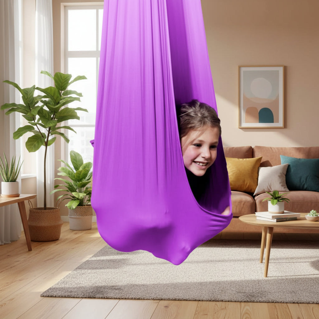 Child enjoying a sensory swing, enhancing focus & calm for developmental and special needs support.