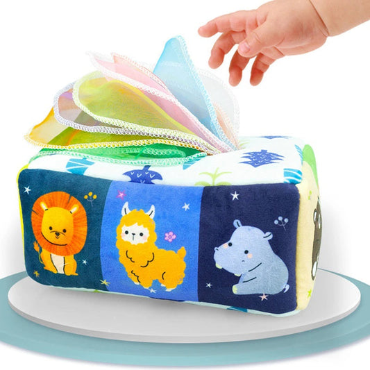 Children's soft fabric tissue box toy with colorful scarves for sensory play and hygiene learning.