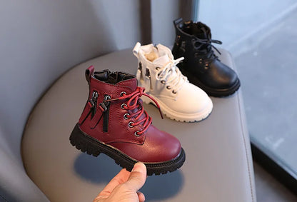 Fashionable black kids' waterproof ankle boots, perfect for wet and cold outdoor fun