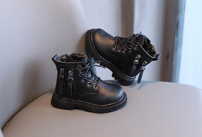 Close-up of children's ankle boot zipper, showing waterproof protection for winter