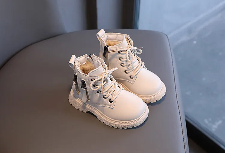 Stylish yellow children's waterproof ankle boots, with black sole and zipper detail.
