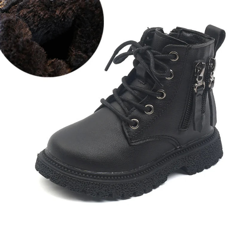 Child's foot wearing black waterproof ankle boot, zip closed, ready for winter play