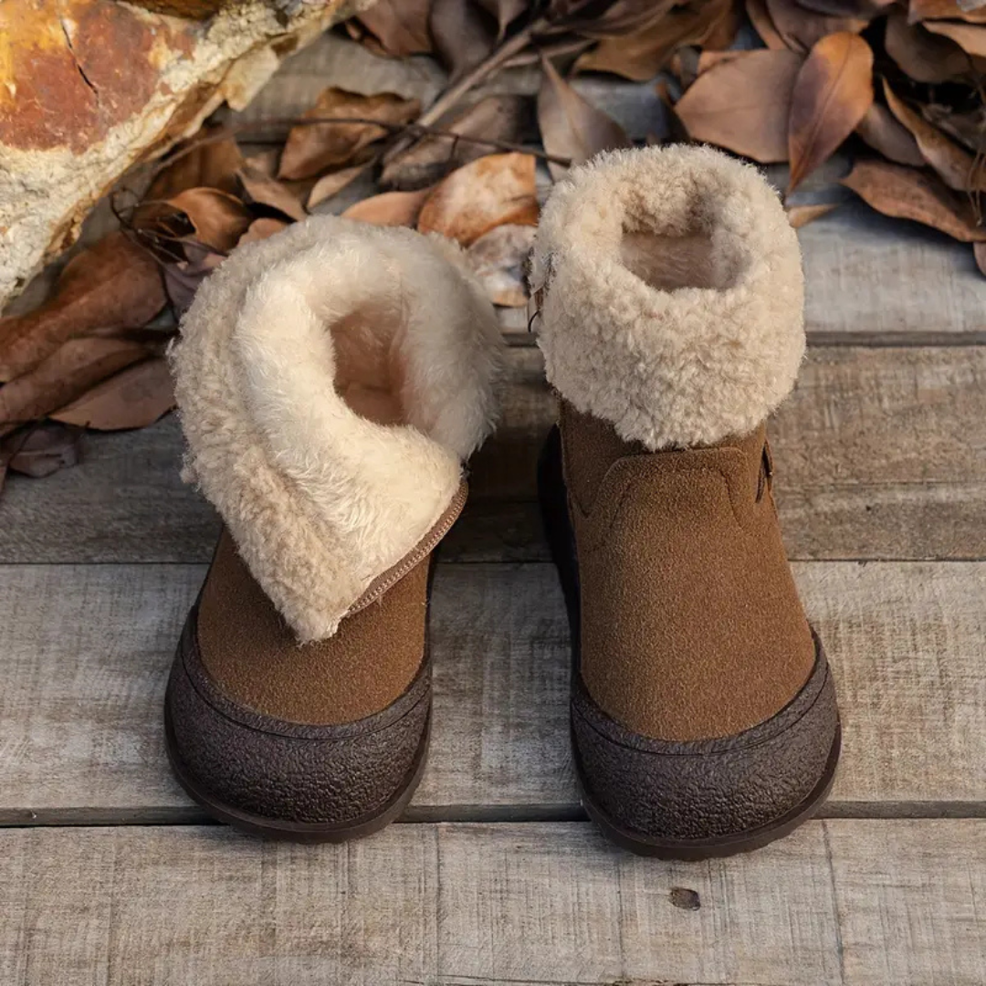 Close-up of children's fleece-lined winter boots, showing quality leather and functional side zipper for easy wear
