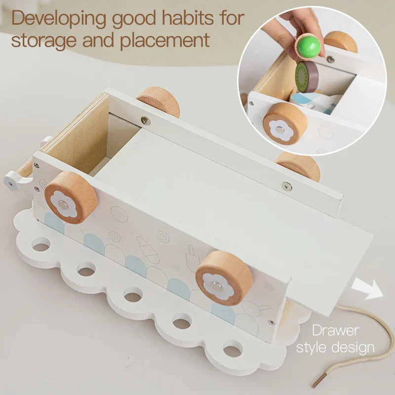 Child playing with a wooden ice cream truck toy and various pretend play desserts