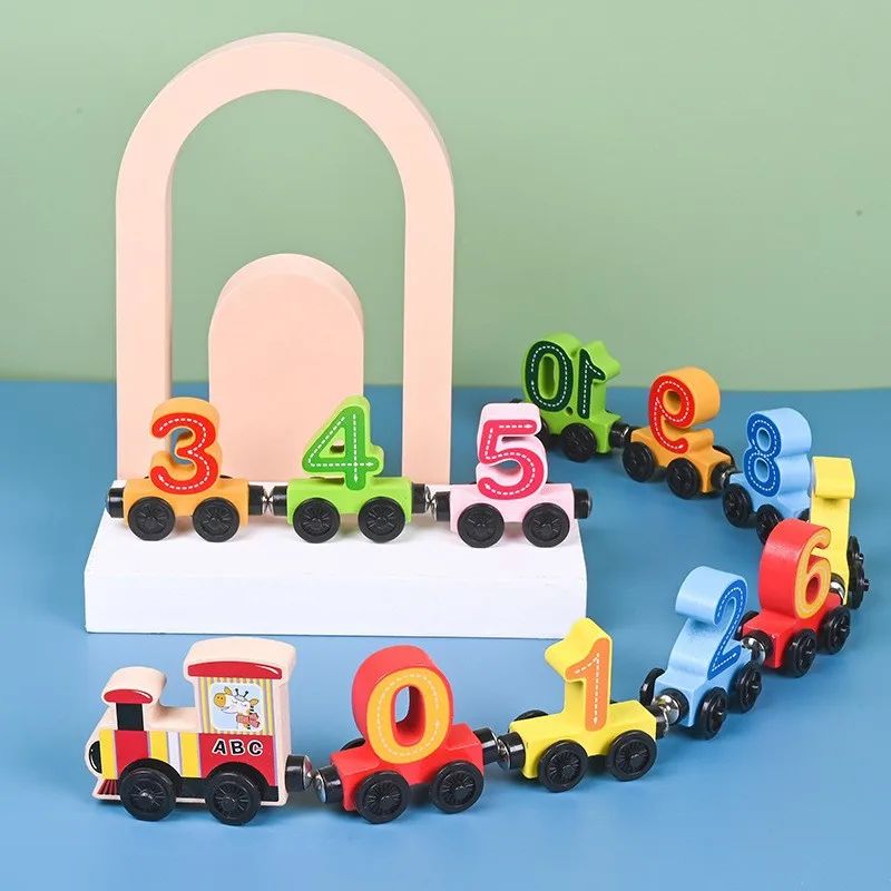 Preschooler arranging wooden magnetic train cars on a track, promoting problem-solving and fine motor skills