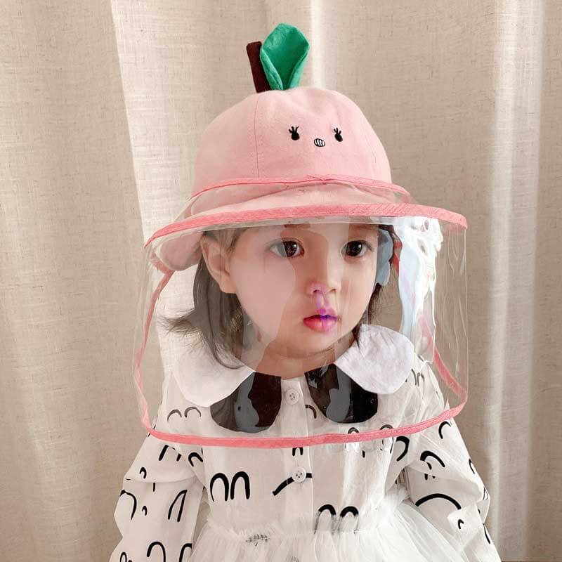 Toddler wearing a yellow children's protective fisherman hat outdoors, side view
