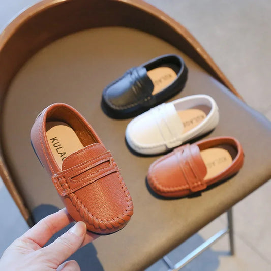 Classic black leather slip-on loafers for boys, ideal for school uniforms and formal events.