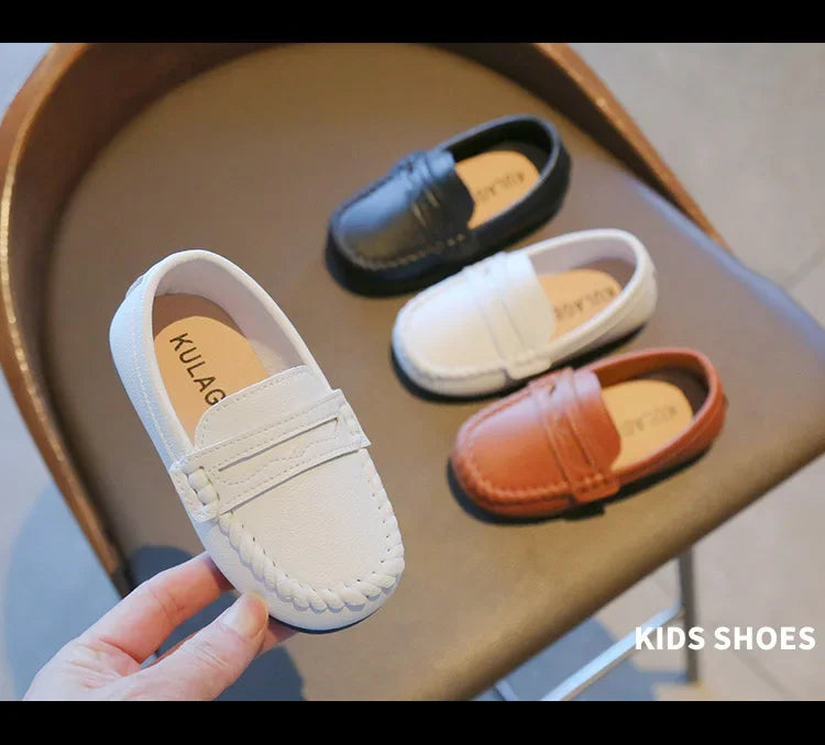 Boys' black leather formal slip-on loafers, easy to wear for school or special events.