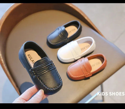 Versatile black leather slip-on kids' loafers, suitable for school, parties, and formal wear.