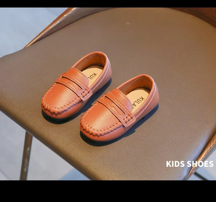 Childrens' black leather slip-on formal loafers, providing comfort and a sophisticated look.