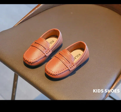 Childrens' black leather slip-on formal loafers, providing comfort and a sophisticated look.