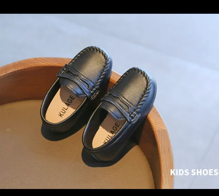 Durable black leather slip-on boys' shoes, designed for active school days and formal events.
