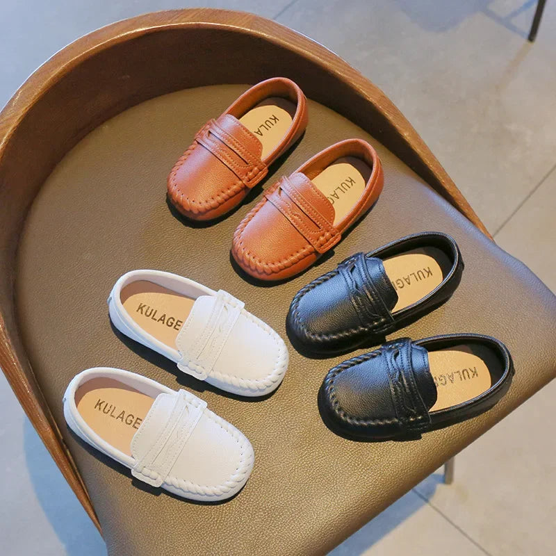 Boys' durable black leather slip-on loafers with no-tie design, perfect for school and formal wear.